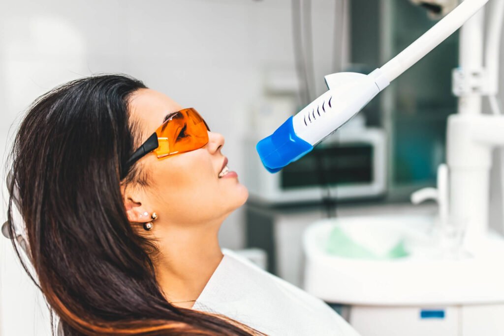 A female patient sits in the dental chair while getting professional teeth whitening in Cameron Park
