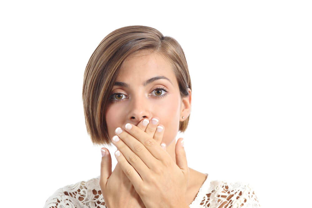 a woman with crooked teeth and bad breath needing to see a Family Dentist Cameron Park