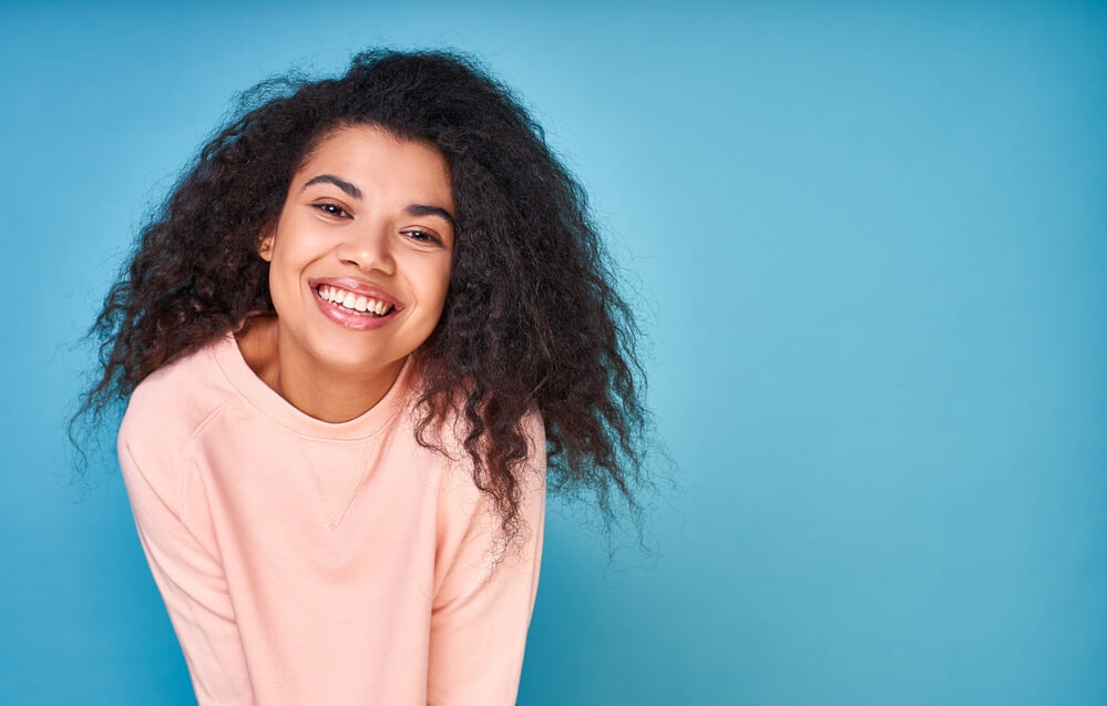 a young woman smiling after getting a professional Teeth Whitening treatment in El Dorado Hills
