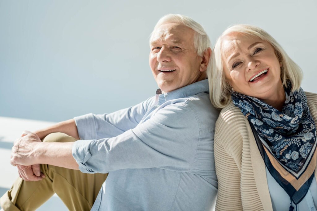 a senior couple smiling after seeing their Dentist in Placerville CA