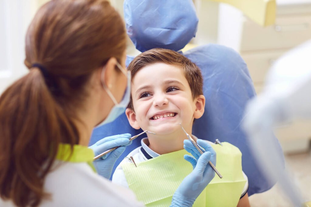 Family Dentist in Cameron Park checking boy's smile