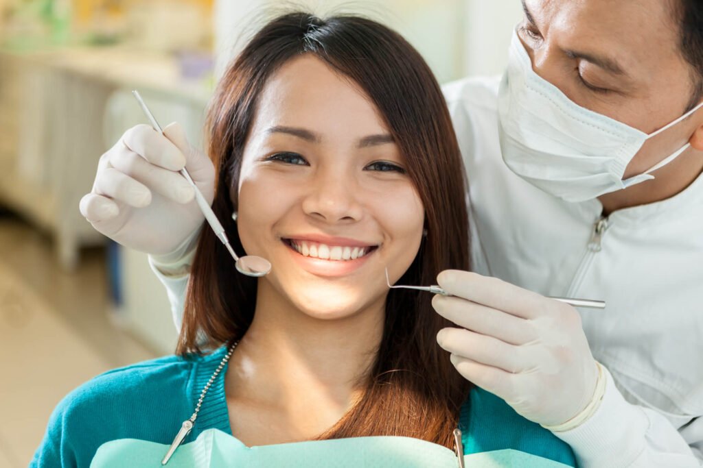 an expert in El Dorado Hills Cosmetic Dentistry checking a female patient's teeth