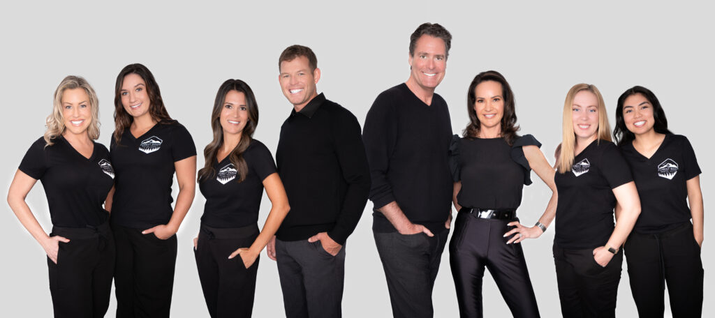 A diverse dental team, smiling and standing together, ready to welcome you at Forest Ridge Dental Health & Wellness