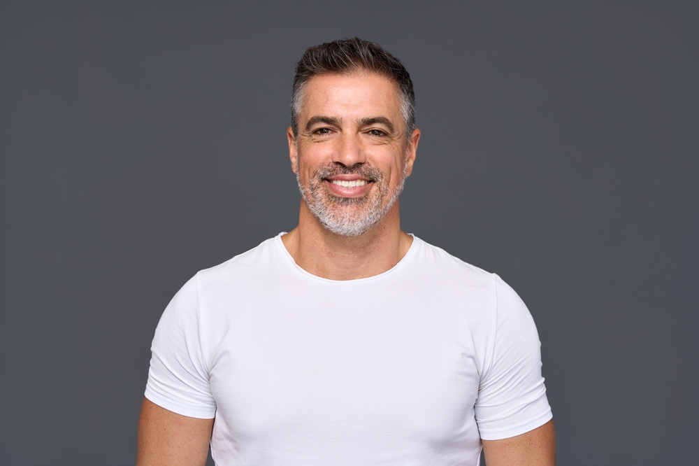 A smiling man with healthy teeth, reflecting the quality care provided by Emergency Dentistry at Forest Ridge Dental Health & Wellness